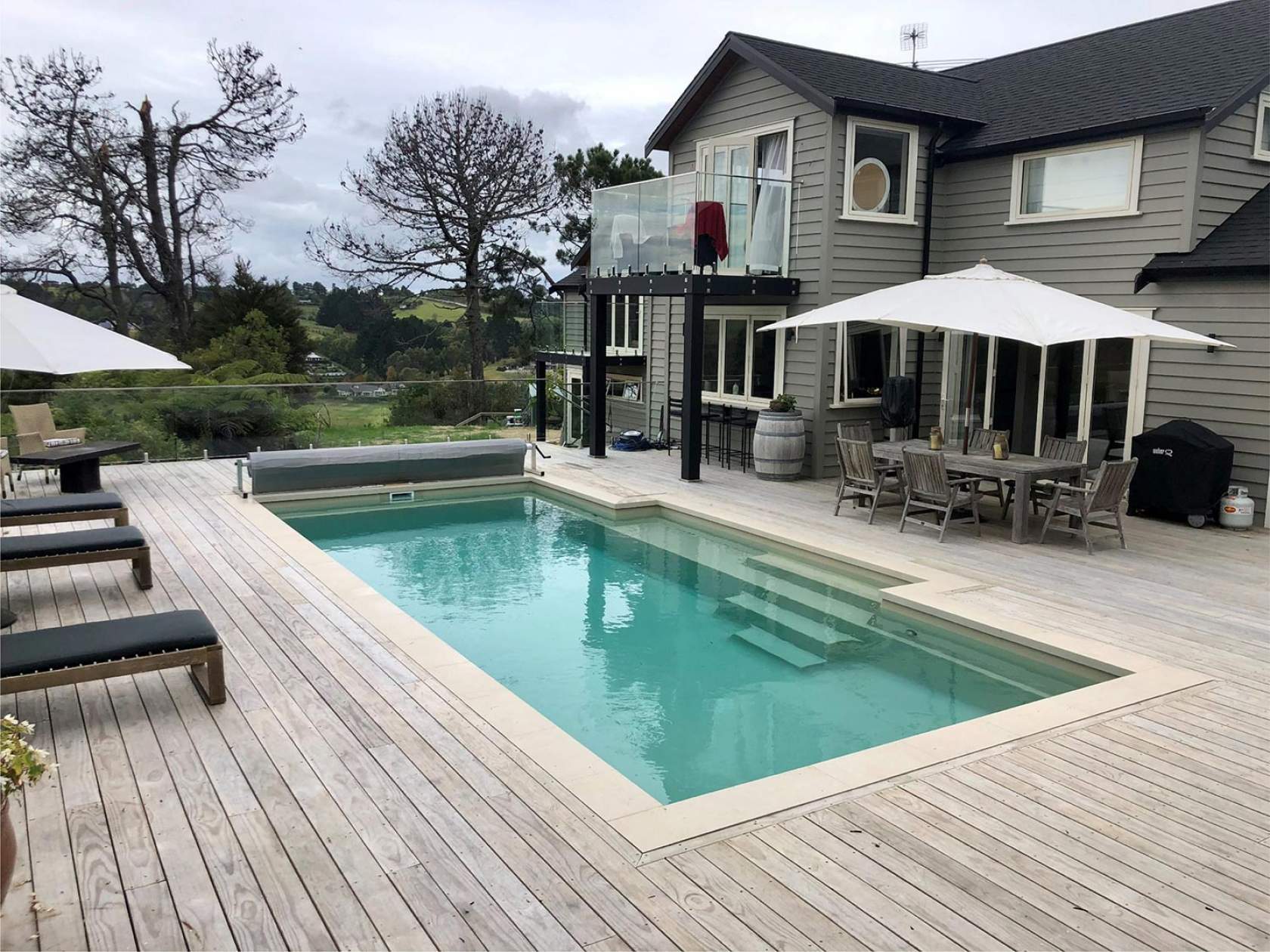 Family enjoying benefits of pool cover - energy savings and safety